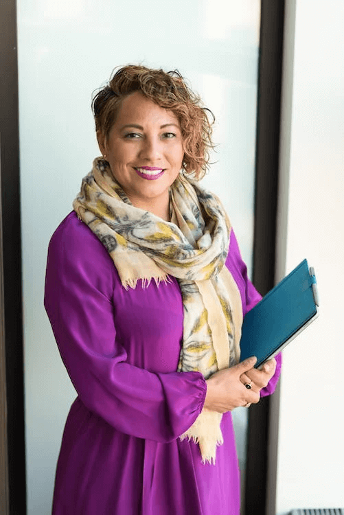 https://www.pexels.com/photo/woman-smiling-and-holding-teal-book-1181424/