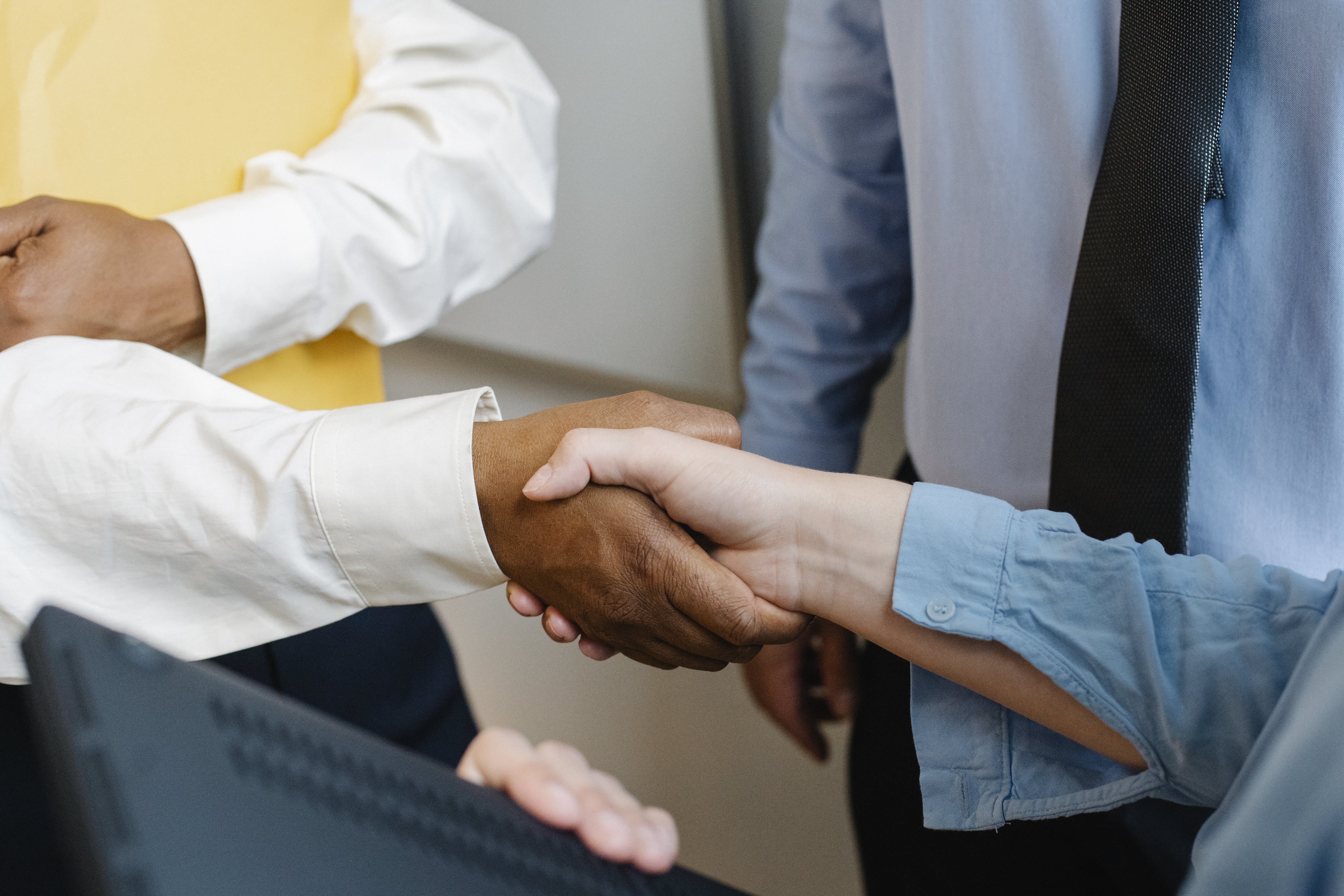 Free Crop anonymous diverse entrepreneurs shaking hands after meeting and negotiating about new project Stock Photo